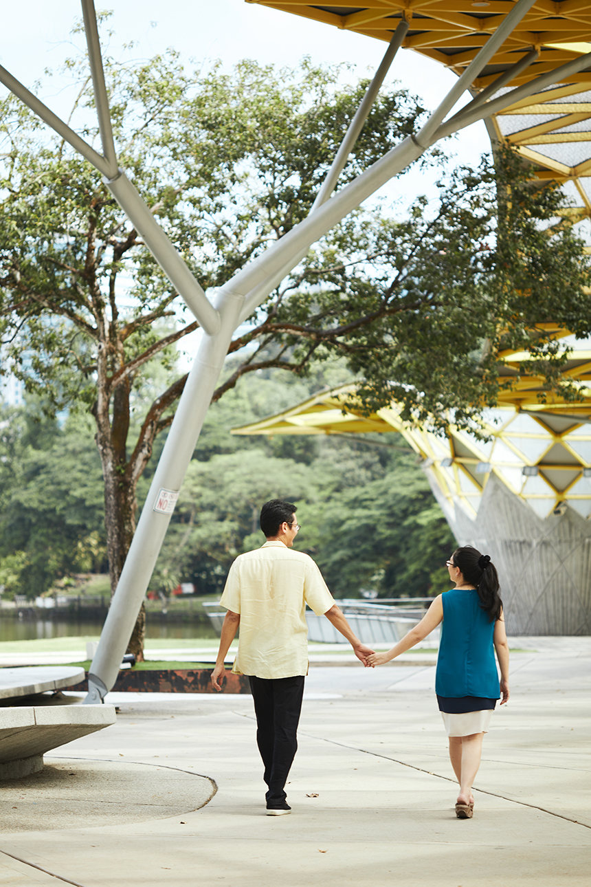 couple holding hands and walking outside